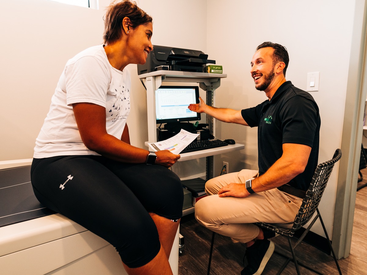 A Prefusion clinician going through results with a client at Prefusion Health