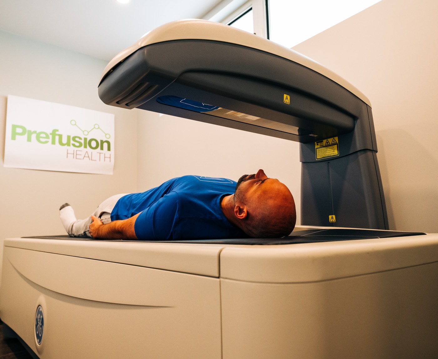 A client on the DEXA scanner at Prefusion Health