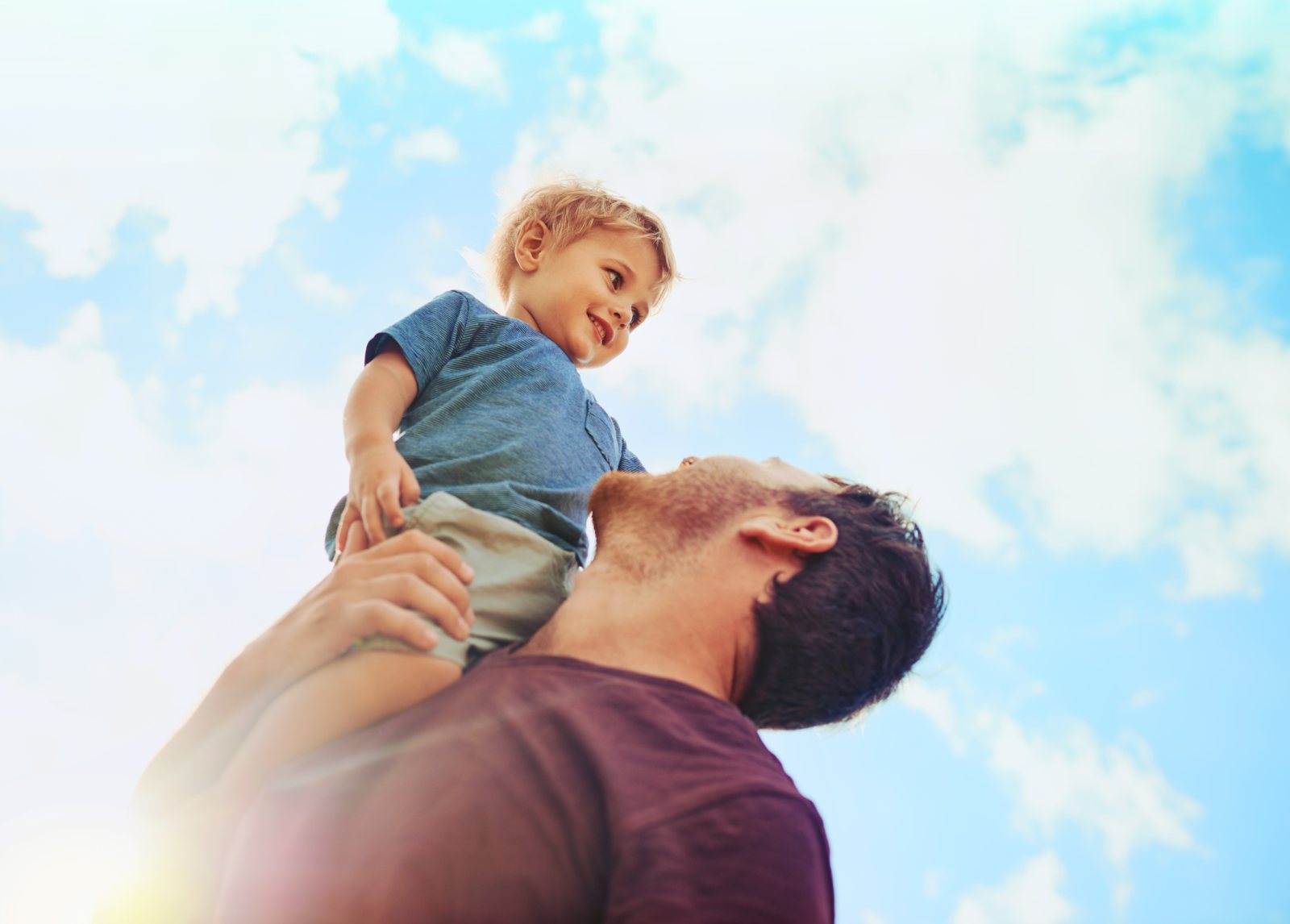 Father lifting his son, full of energy